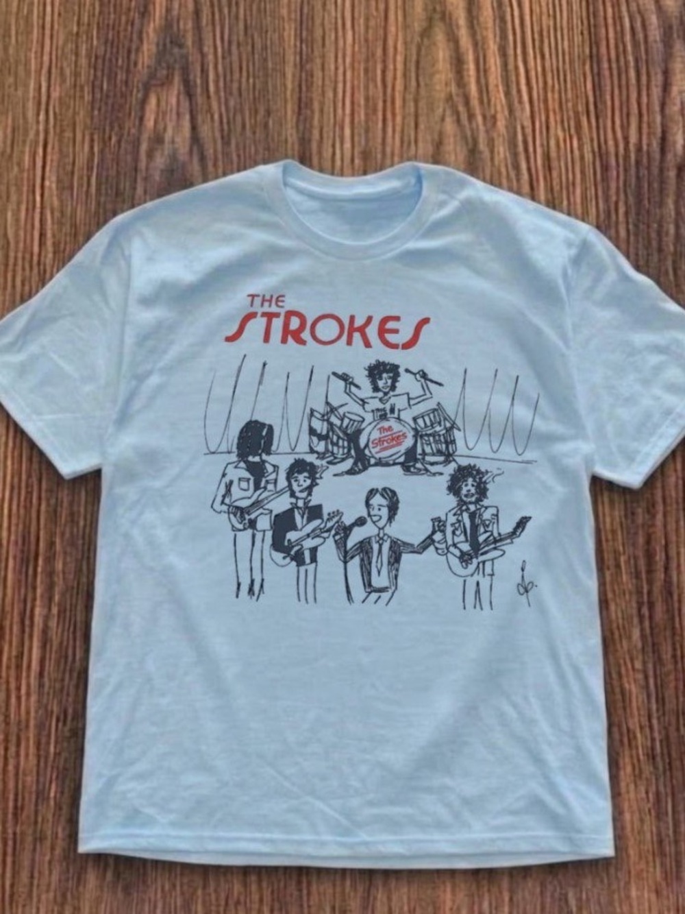 The strokes band tee, four members playing instruments shirt